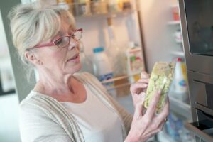 woman reading food package label