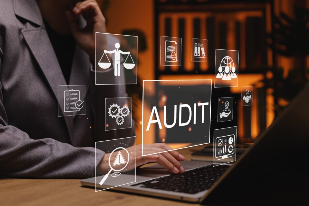 Business audit and compliance concept. Business professional working on laptop with audit and compliance icons, representing financial auditing, risk management, quality control, corporate governance,